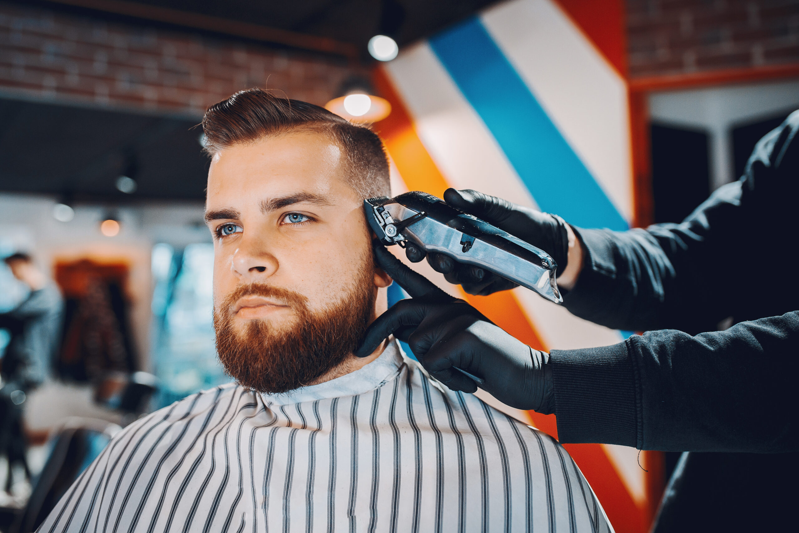 Man with a beard. Hairdresser with a client.